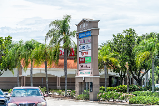 Naples, USA - August 5, 2021: Carillon Place strip mall entrance business sign for Ross, Walmart Neighborhood market in Naples Southwest Florida
