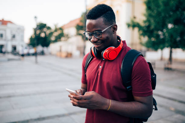 istock Young African American man using a smart phone outdoors 1372197880