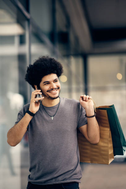 istock Happy Middle Easter man talking on the phone while shopping in the city. 1372198616