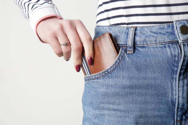 istock Brown leather wallet in jeans pocket 1372200320