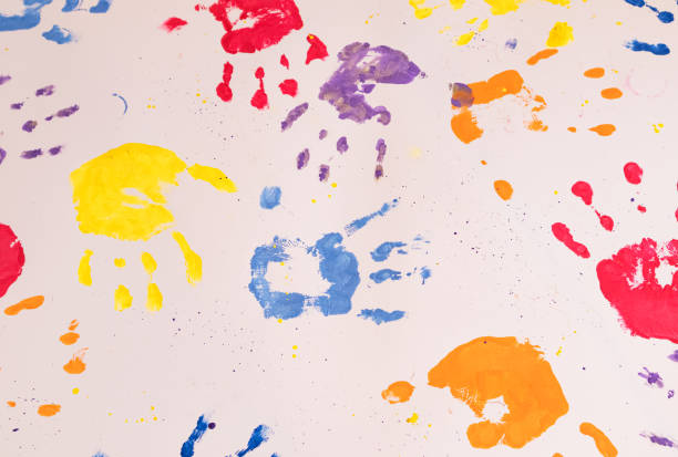 istock Colored children's hand prints on a white background. Top view, flat position. 1372200363