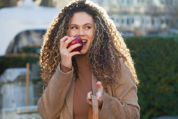 istock Young woman eating an apple 1372200584