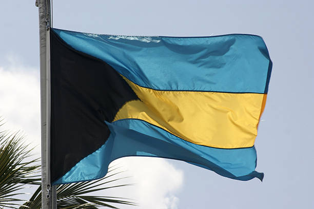 Flag of the Bahamas flying high in the breeze on a wonderful tropical day.