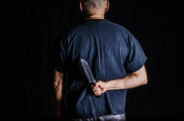 istock Man holding kitchen knife in his back 1372202816