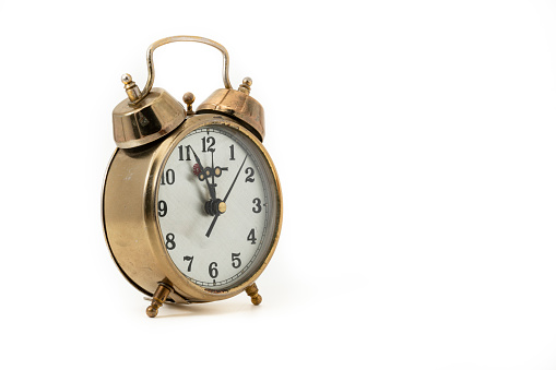 classic bell alarm clock, isolated on white background, black metal object front view still life