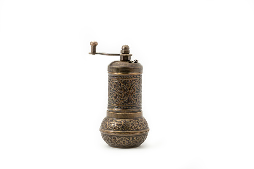 Vintage manual spice grinder. Antique spice mill isolated on white background.