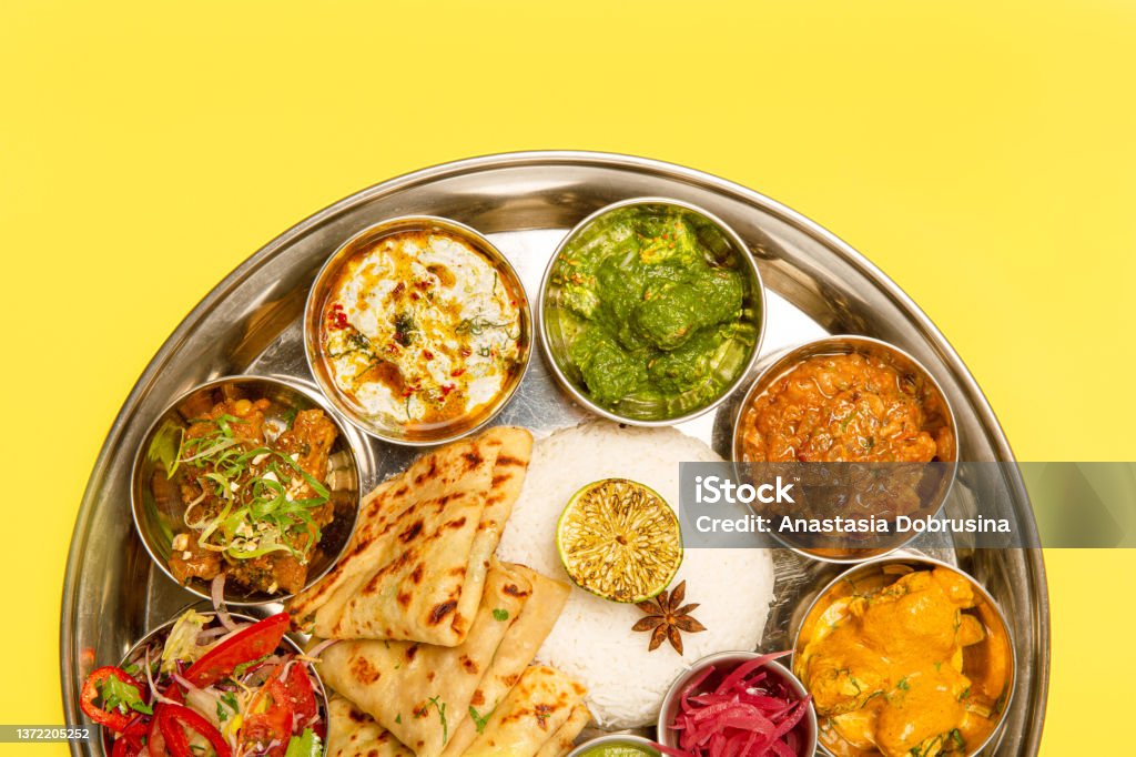 Traditional Indian food Thali served in plate. Top view. Typical south Indian Thali dishes served in a variety of traditional plates. Thallus Stock Photo