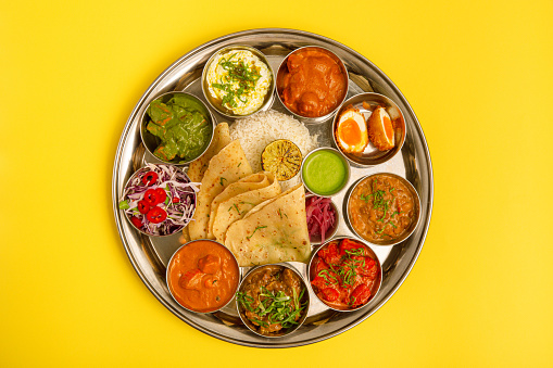 Typical south Indian Thali dishes served in a variety of traditional plates.