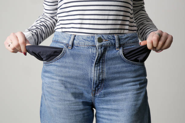istock Woman showing her empty pockets. No money concept. 1372206433