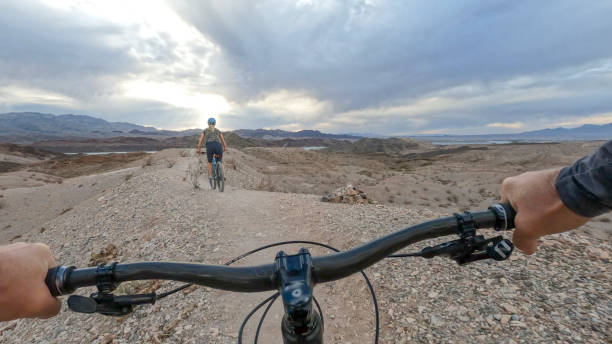 istock Female mountain biker follows desert pathway 1372210128