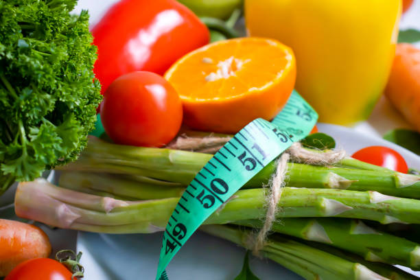 istock fresh vegetables, measuring tape on wooden background 1372210511