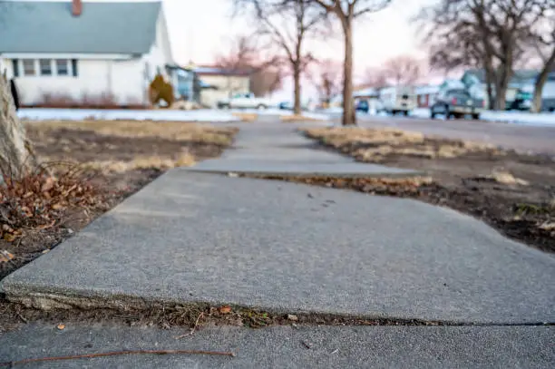 Photo of Frost heave crack in residential concrete sidewalk