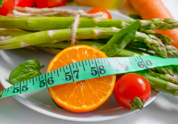 istock fresh vegetables, measuring tape on wooden background 1372210912