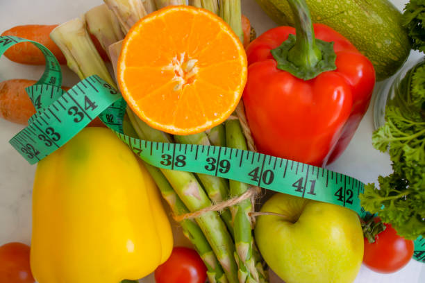 istock fresh vegetables, measuring tape on wooden background 1372212281
