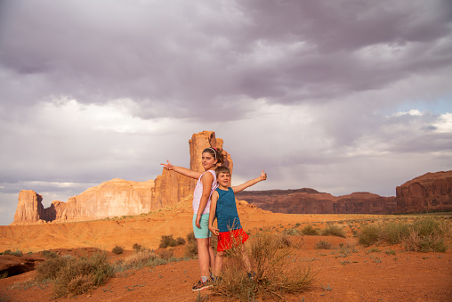 Famous place. Usa. Utah. Tourist children on vacation in the Monument valley.