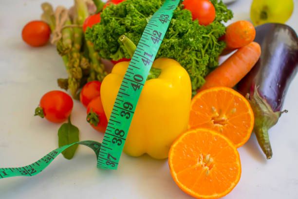istock fresh vegetables, measuring tape on wooden background 1372212588