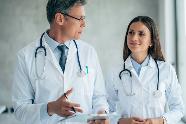 istock Two healthcare workers talking at hospital 1372217140