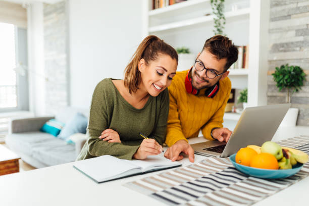 istock Caucasian couple working from home using a laptop 1372217358