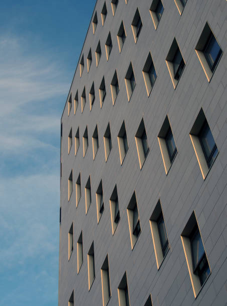 istock close up perspective view of a modern apartment development with white stone cladding and diagonal windows against a bright blue sky 1372220213