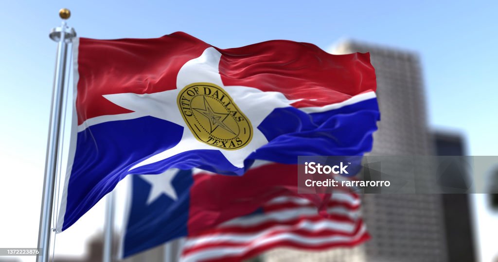 Dallas city flag waving in the wind with Texas state and United States national flags Dallas city flag waving in the wind with Texas state and United States national flags blurred in background Dallas - Texas Stock Photo