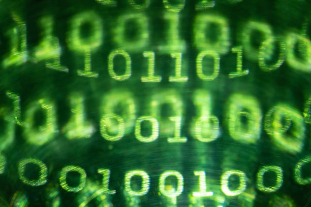 Photo of green colored binary code flowing on black background. Shot with a full frame mirrorless camera. No people are seen in frame.