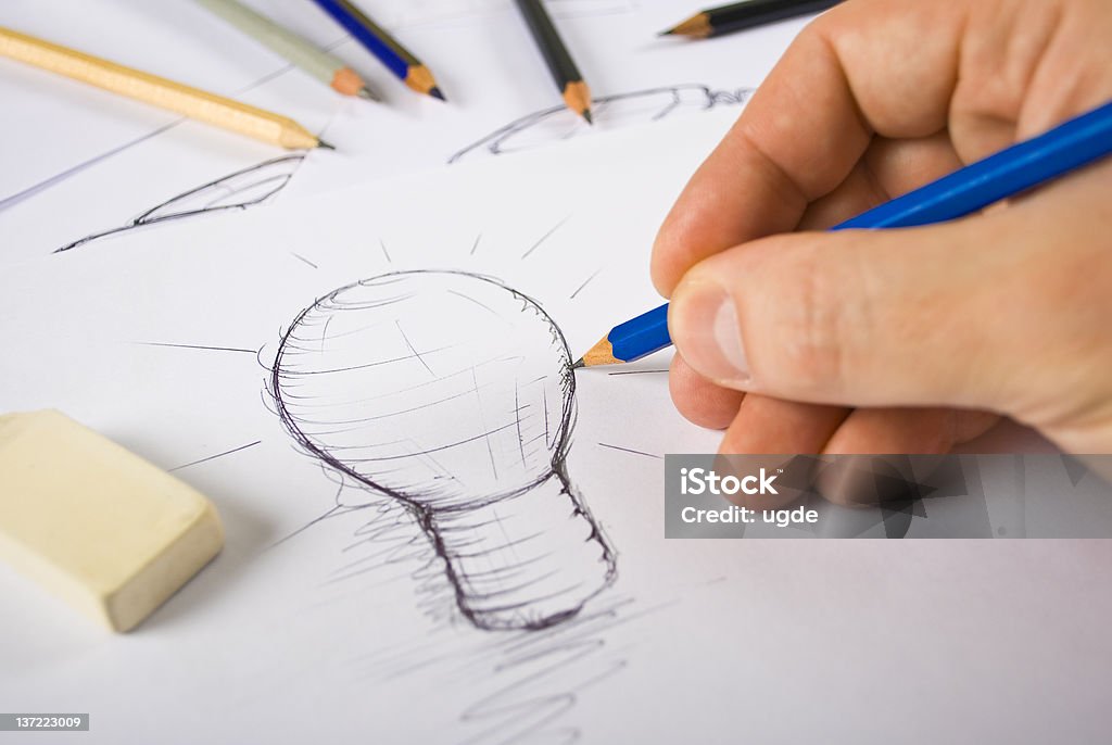 Designer Drawing A designer drawing sketches Advertisement Stock Photo