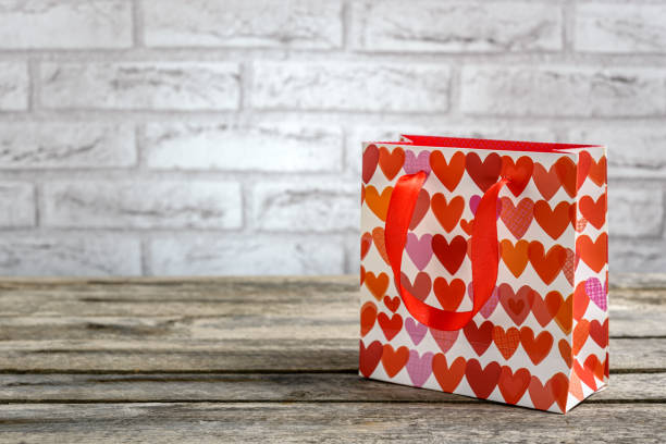 Empty red colored Valentine card on colorful romantic background with drawn hearts