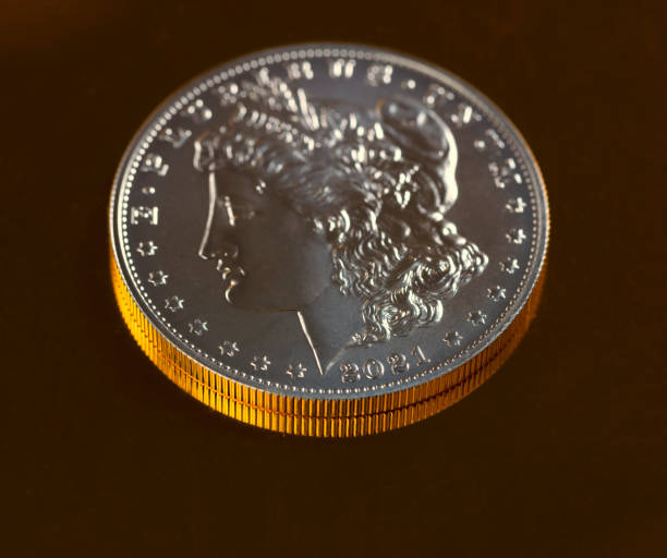 istock Close up of 2021 silver dollar on reflecting gold background 1372251439