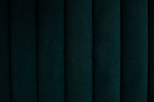 Background green velour textile, suede velvet sofa. Soft stripes backdrop, couch seat. Macro fashion photo. Close up