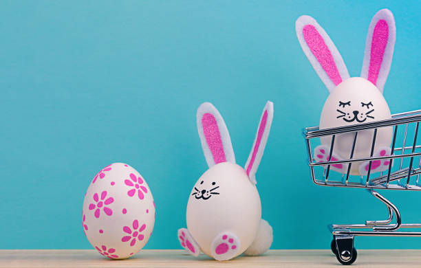 istock Easter eggs with bunny ears and mini grocery cart. 1372257293