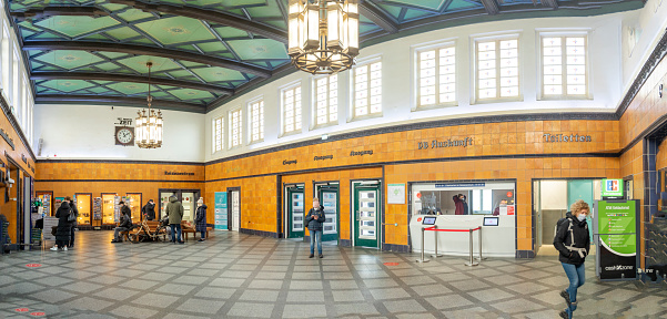 Westerland, Germany  February 17, 2022: people buy rtain tickets in the historic train station of Westerland in Sylt, Germany.Westerland, Germany  February 17, 2022: people buy train tickets in the historic train station of Westerland in Sylt, Germany.