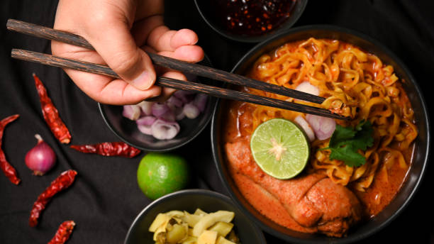 istock A female hands using chopsticks eating Khao Soi Kai 1372259837