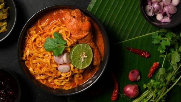 istock Top view, Khao Soi Kai bowl over green banana leaf background 1372259859