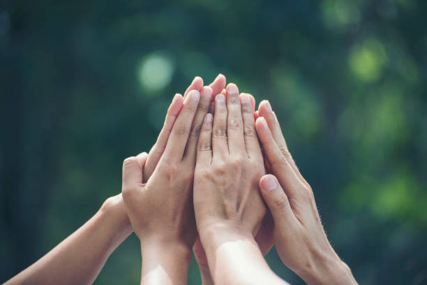 istock Group of teamwork high five team together hands raise up power partner. Diversity multiethnic group of business people success team together. Collaborate Volunteer friendship mission Business partner 1372260690