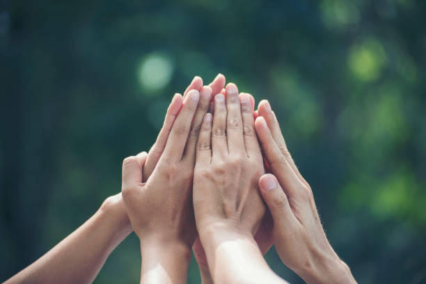Group of teamwork high five team together hands raise up power partner. Diversity multiethnic group of business people success team together. Collaborate Volunteer friendship mission Business partner stock photo