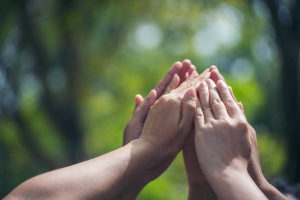 istock Group of teamwork high five team together hands raise up power partner. Diversity multiethnic group of business people success team together. Collaborate Volunteer friendship mission Business partner 1372260702