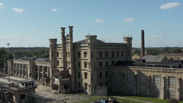 Aerial view of the derelict and abandoned Joliet prison or jail, a historic site since in the 1880s. Drone taking aerial shot and coming down to capture view of front gate.
