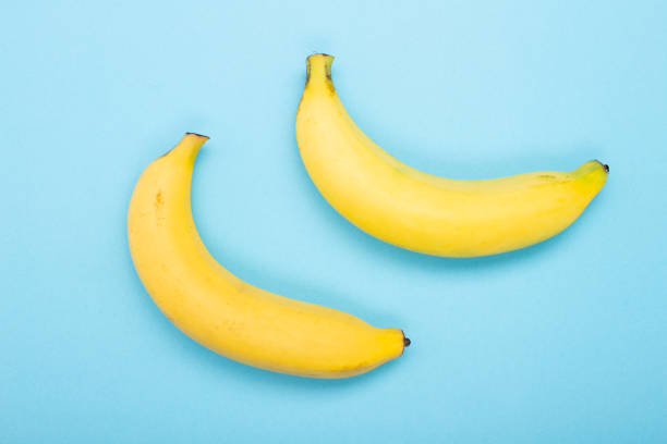 istock Two Banana isolated on blue background 1372262764