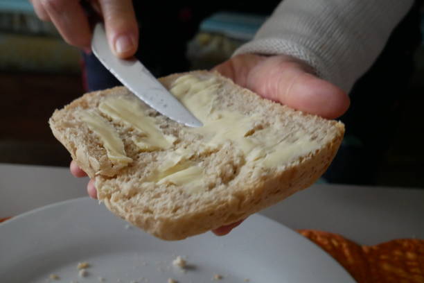 istock Spread butter on homemade bread. Homebread from bread machine. Close-up 1372265833
