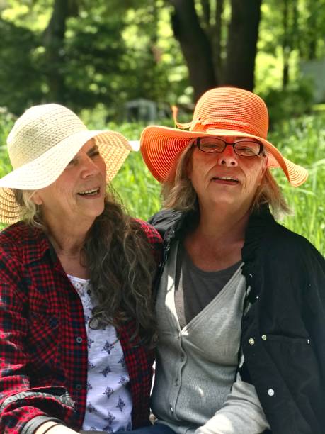 istock Straw hat senior sisters, laughing and playing in the Meadow. 1372269536