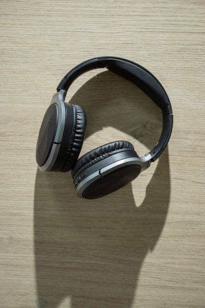 istock Bluetooth headphones placed on a wooden table 1372272317