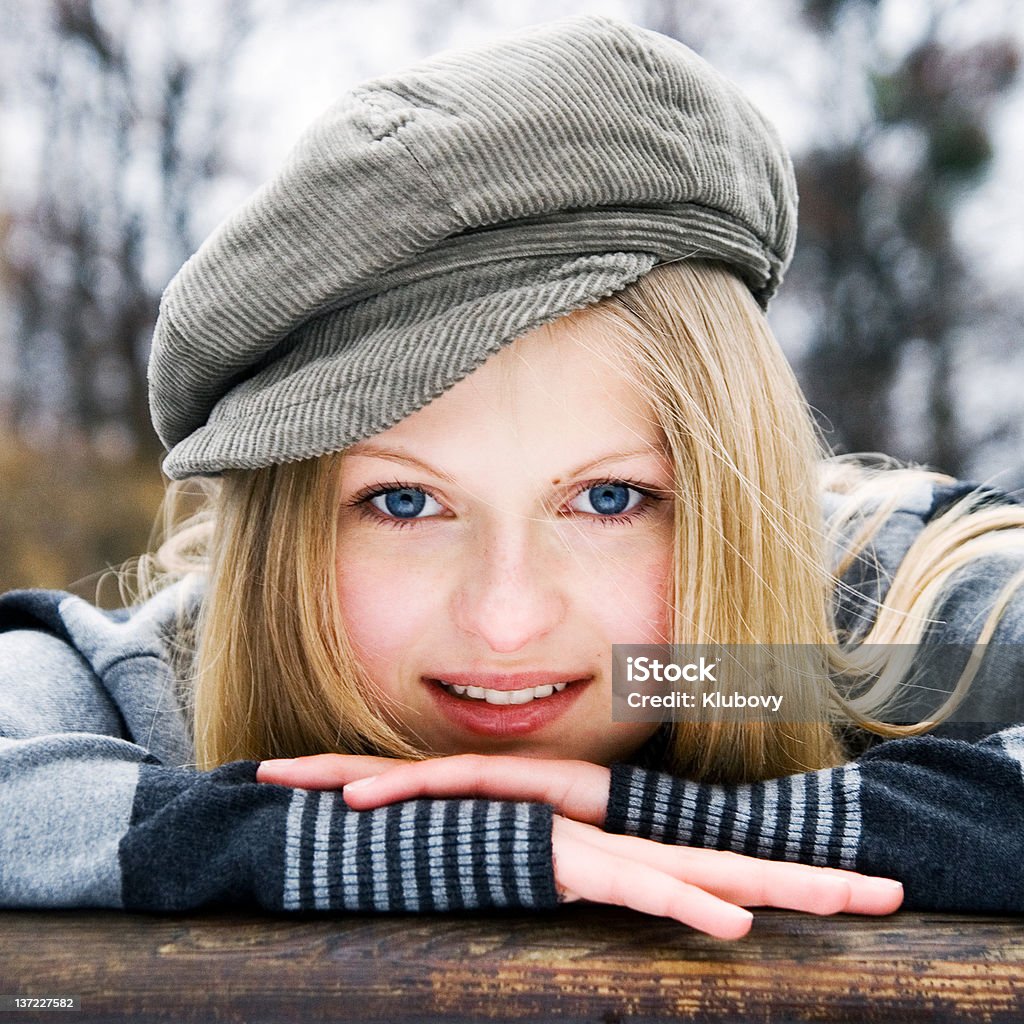 Cheerful blonde Portrait of a beautiful blonde teenage girl in corduroy cap. Corduroy Material Stock Photo