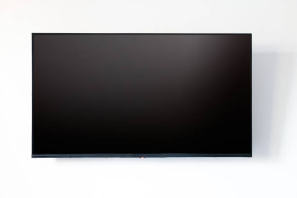 tv blank flat screen on white wall background. black empty television display front view, copy space - flatscreen stockfoto's en -beelden