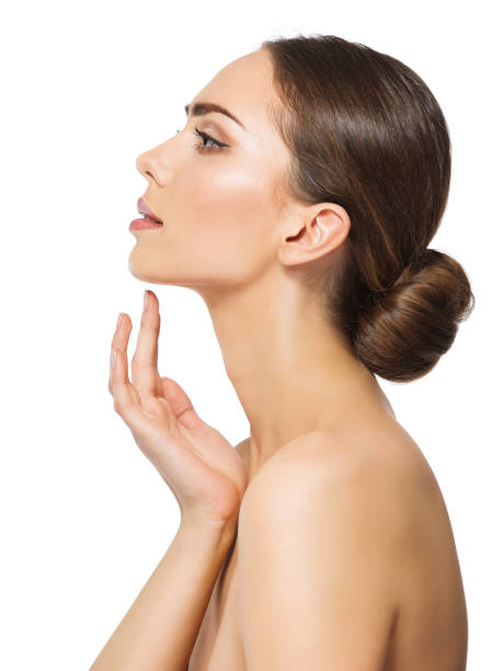 Woman Face Profile. Perfect Women Nose Side view. Facial Model showing with Finger on Slim Chin and Neck. Facelift Massage and Plastic Surgery Concept over White isolated stock photo