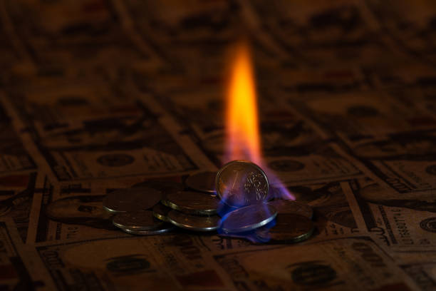 Large-denomination American and European banknotes going up in flames, representing economic crisis, inflation, and so on.