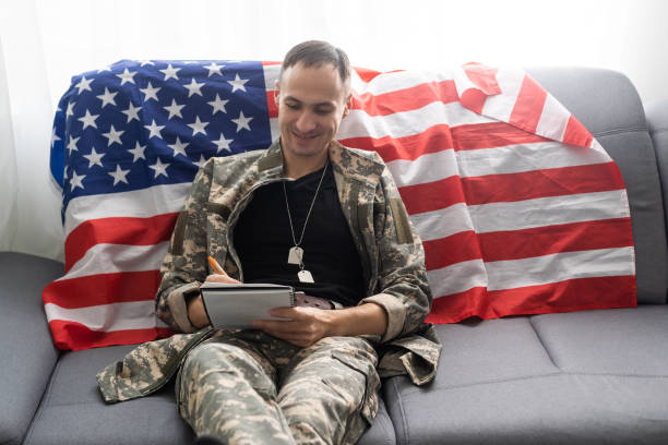 istock Young American soldier sitting and taking notes. 1372285605