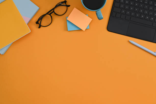 istock Computer laptop, glasses, coffee cup and notebook on yellow background. Flat lay. 1372285782
