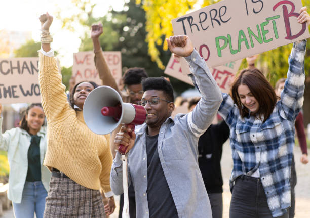 istock Young adult activists holding large placards 1372286415
