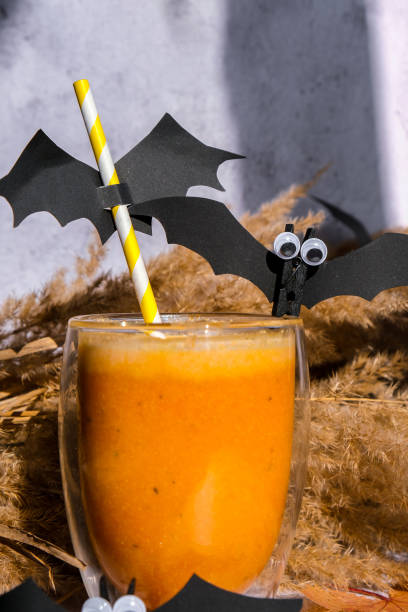 istock Pumpkin smoothie spiced latte. Fall Drinks for Halloween decorations with bat on straw. Holiday drink Autumn coffee with spicy pumpkin flavor seasonal hot drink. Preparation for party 1372286744
