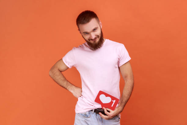 istock Man with Heart Like counter button smiling with pleasure expression rejoicing popularity on Internet 1372288459